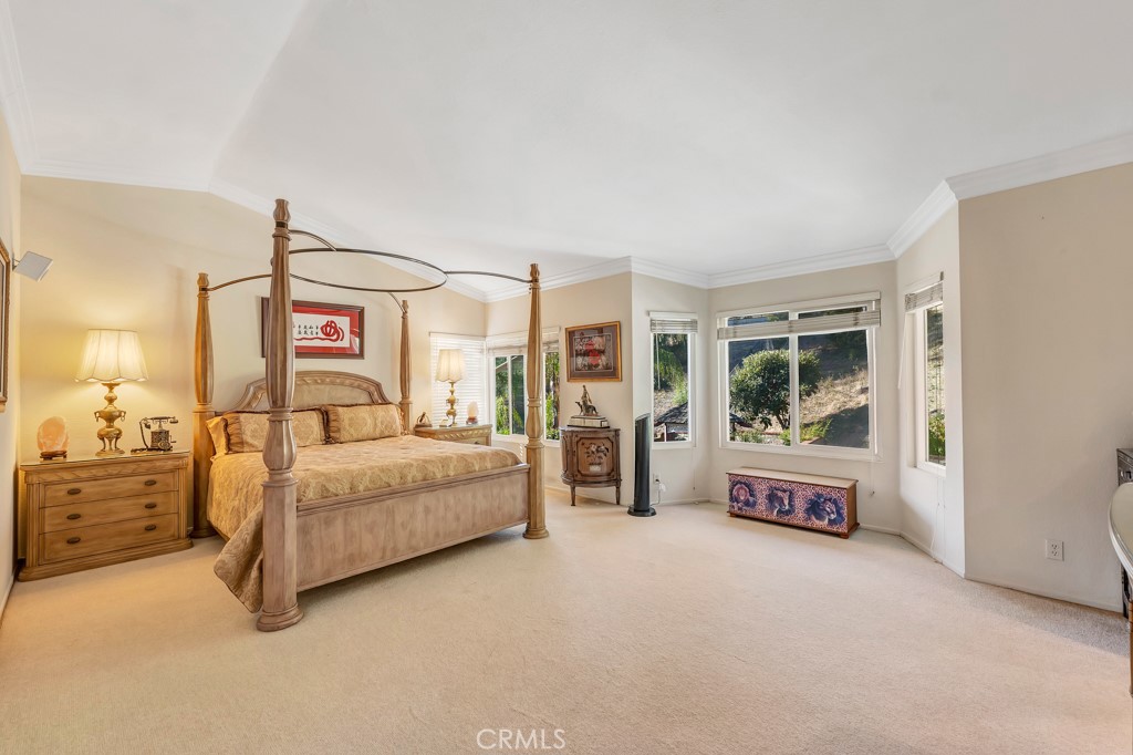 24338 Delta Drive Diamond Bar, CA 91765 - Photo 13 of 20 a spacious bedroom with a bed and a chandelier