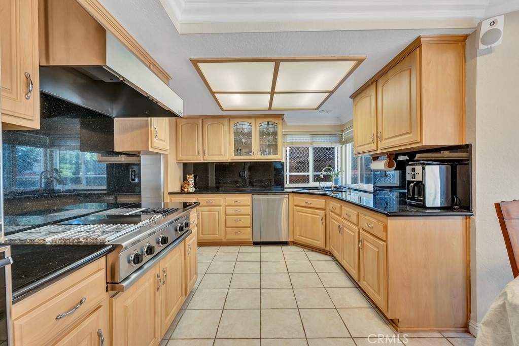 24338 Delta Drive Diamond Bar, CA 91765 - Photo 7 of 20 a kitchen with stainless steel appliances granite countertop a stove a sink and a microwave