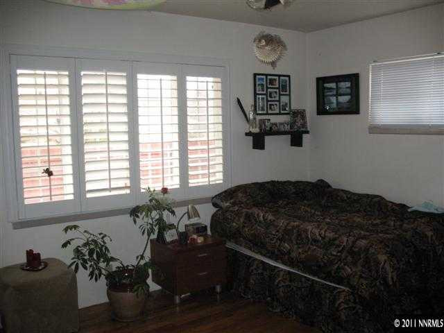 905 Robin Street Reno, NV 89509 - Photo 5 of 8 a bedroom with a bed mirror and window