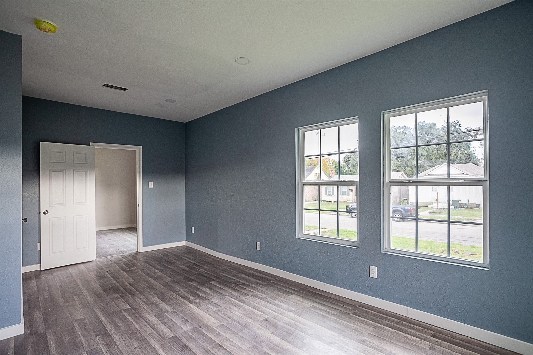 2630 Hazel Avenue Beaumont, TX 77702 - Photo 12 of 30 a view of an empty room with wooden floor and a window