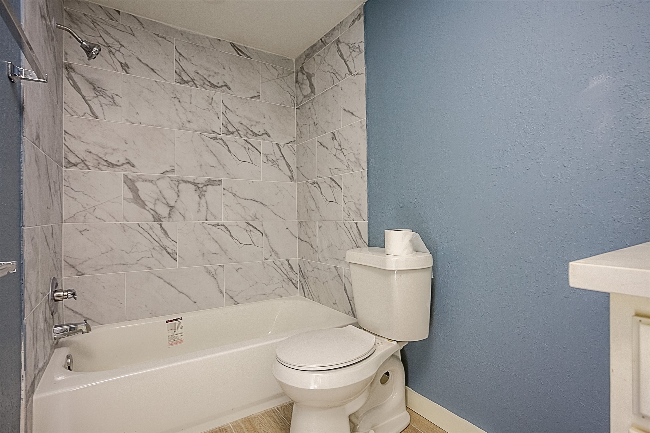 2630 Hazel Avenue Beaumont, TX 77702 - Photo 24 of 30 a white toilet sitting next to a bath tub and a shower curtain