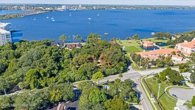 an aerial view of a house with a garden and swimming pool