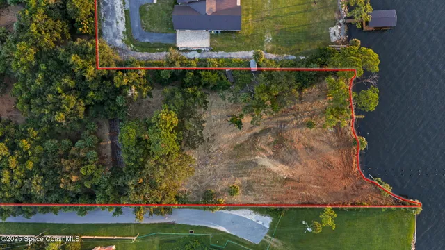 a view of a yard with wooden fence