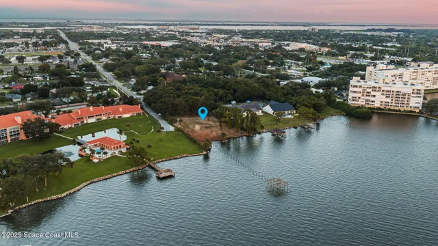 an aerial view of lake and residential houses with outdoor space