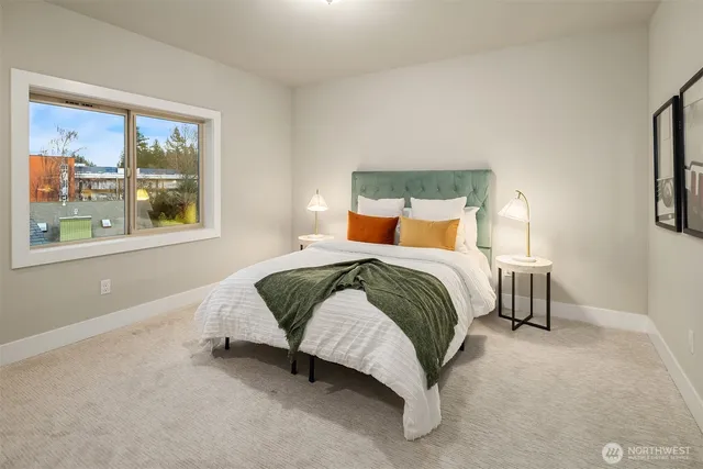 a bedroom with a bed lamp and window