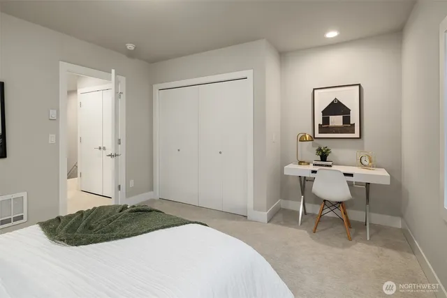 a bedroom with a bed and a chair