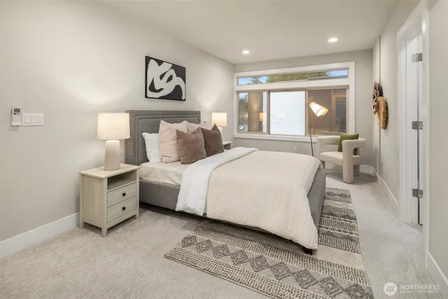 a spacious bedroom with a large bed and a chandelier