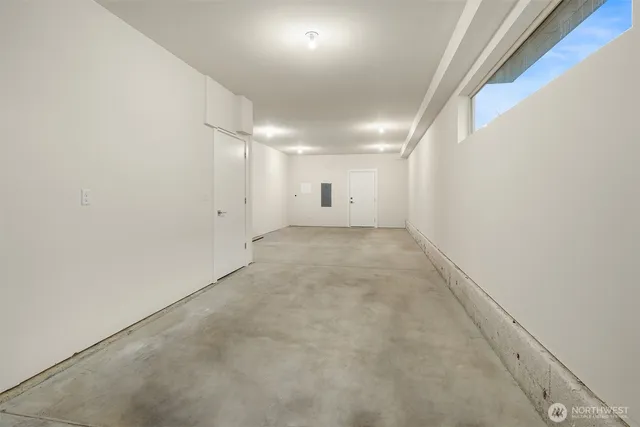 an empty room with a empty space and windows