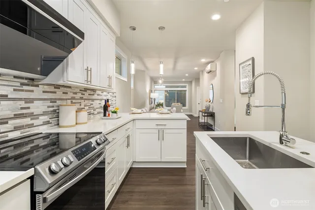 a kitchen with a sink stove top oven and cabinets