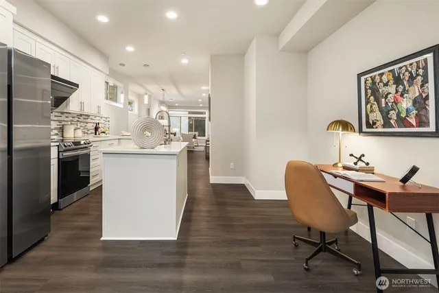 a view of a dining room with furniture a kitchen and chandelier