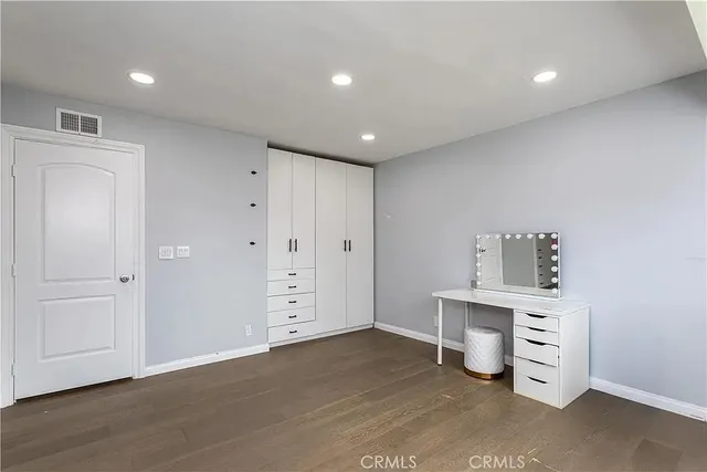 a view of room with window and wooden floor
