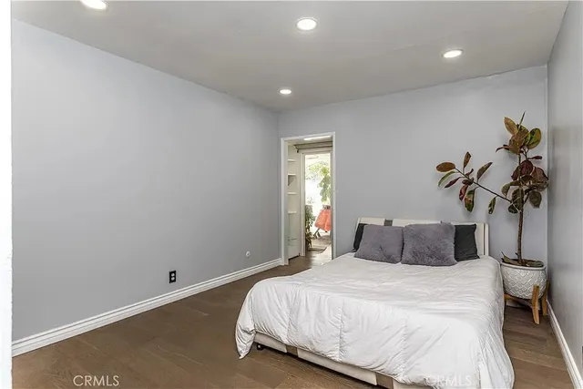 a spacious bedroom with a bed and a window