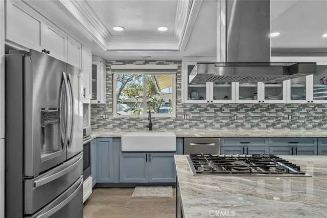 a kitchen with stainless steel appliances granite countertop a stove refrigerator and cabinets