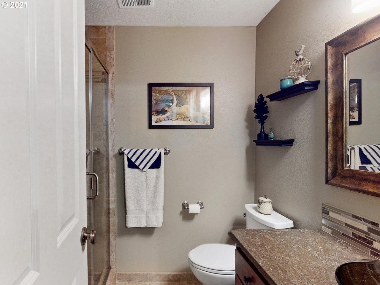 1324 S Street Springfield, OR 97477 - Photo 14 of 32 a bathroom with a granite countertop sink mirror vanity and toilet