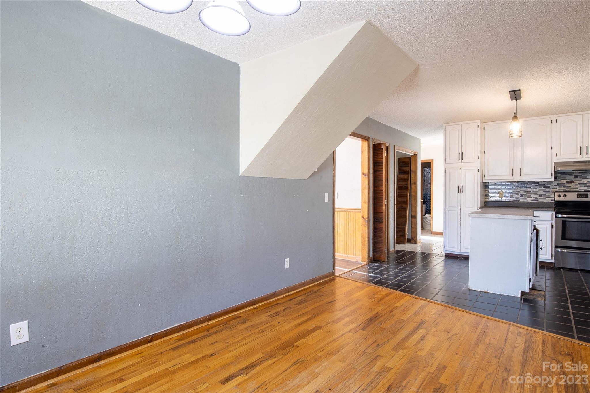 3954 Highway 80 Bakersville, NC 28705 - Photo 12 of 34 a view of a room with wooden floor and a kitchen