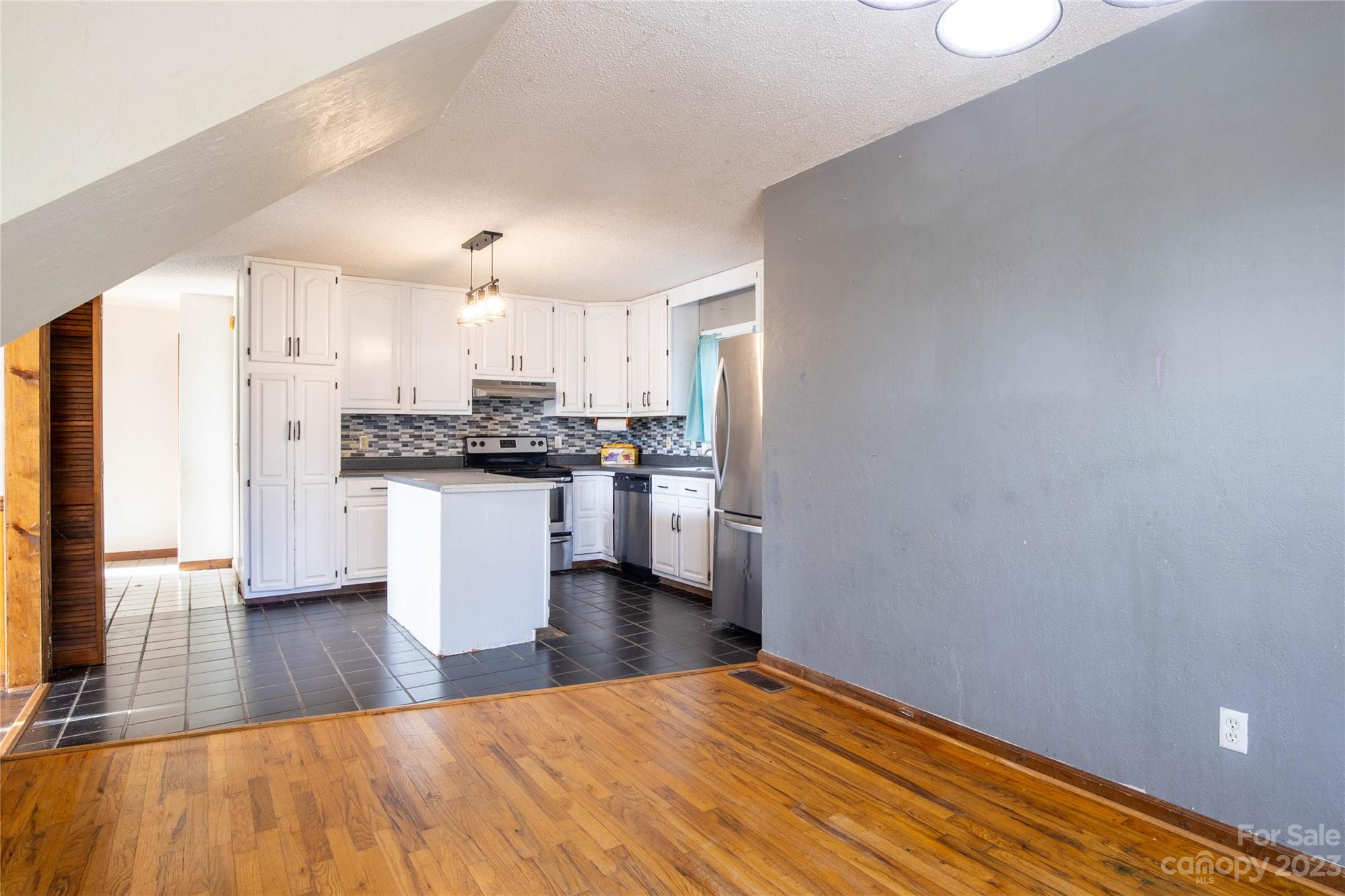 3954 Highway 80 Bakersville, NC 28705 - Photo 13 of 34 a kitchen with stainless steel appliances a refrigerator and wooden floor