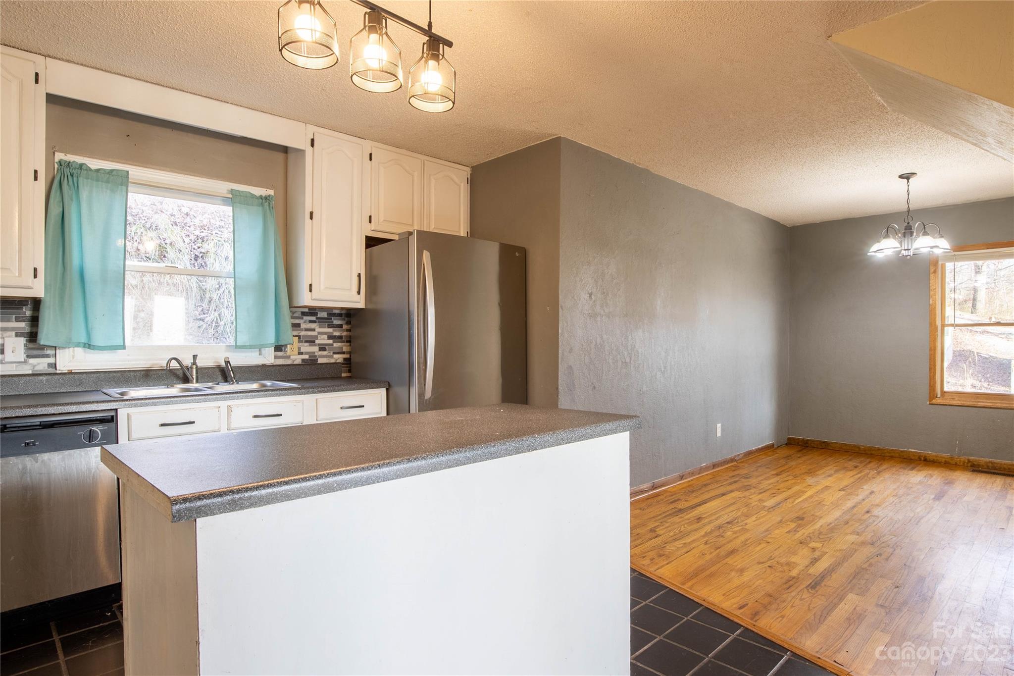 3954 Highway 80 Bakersville, NC 28705 - Photo 15 of 34 a kitchen with stainless steel appliances a refrigerator and a stove