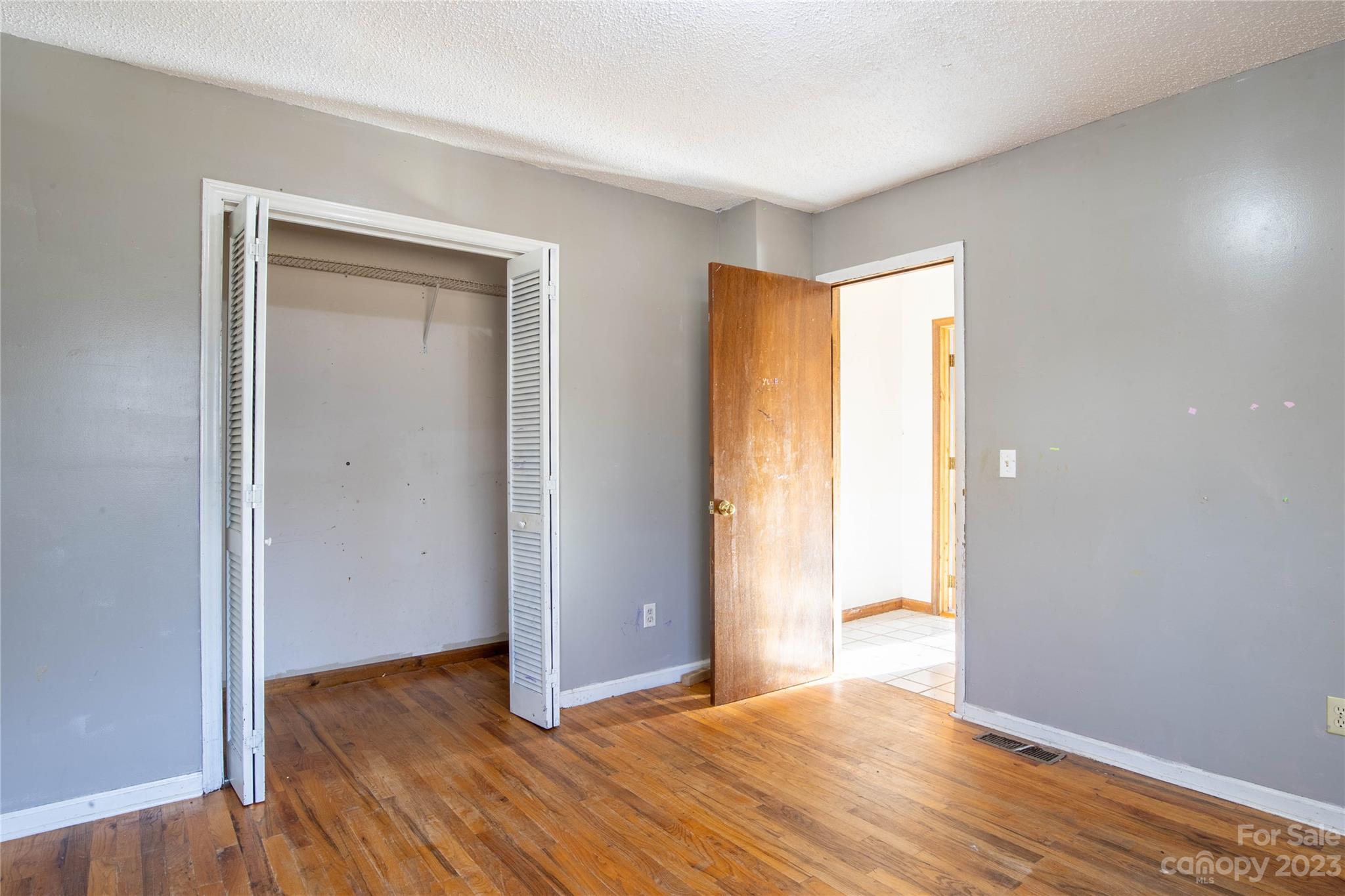 3954 Highway 80 Bakersville, NC 28705 - Photo 19 of 34 a view of an empty room with wooden floor and a window