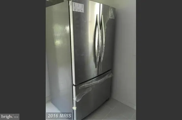 a view of a refrigerator in kitchen