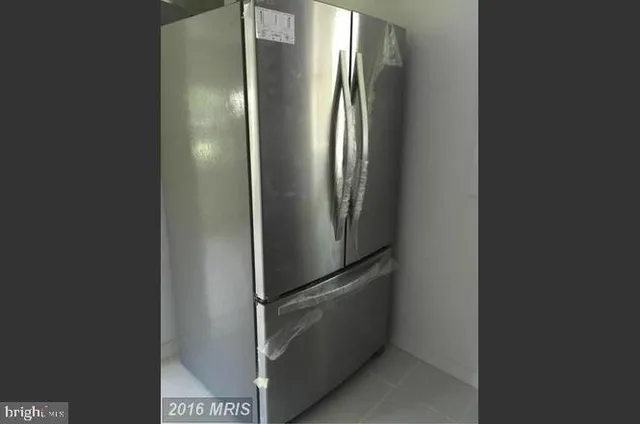 a view of a refrigerator in kitchen