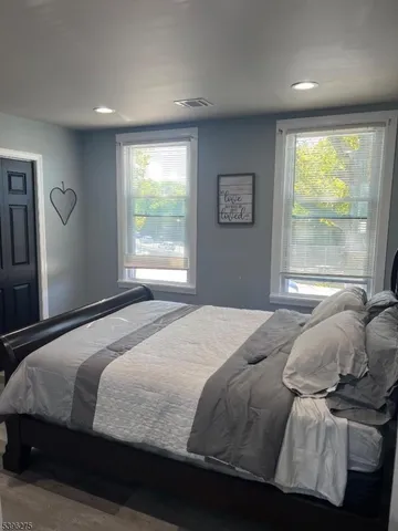 a bedroom with a large bed and a large window
