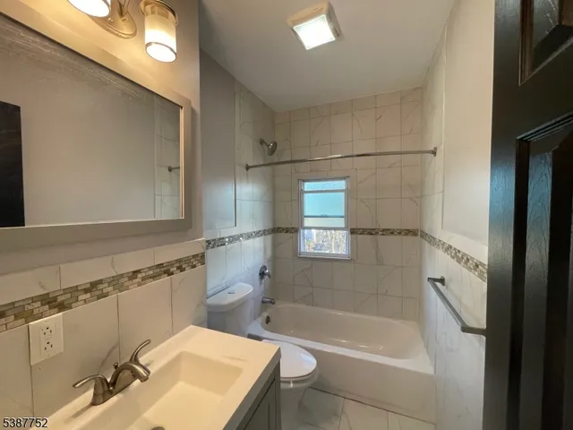 a white bath tub sitting next to a bathroom sink
