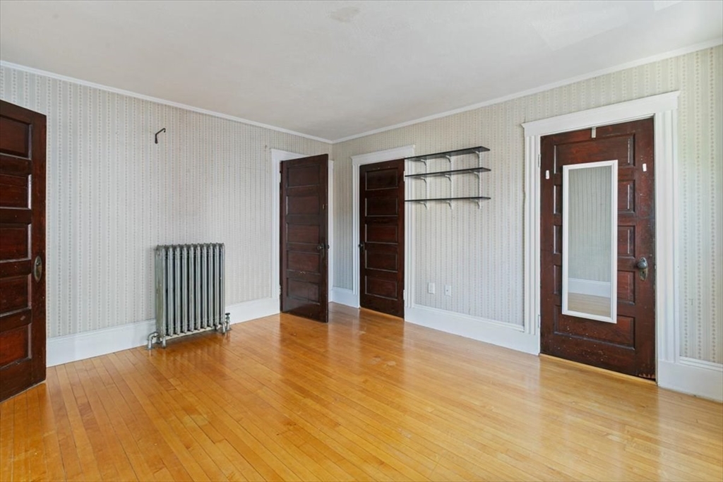 98 Webster Street Haverhill, MA 01830 - Photo 28 of 42 a view of an empty room with wooden floor and a window