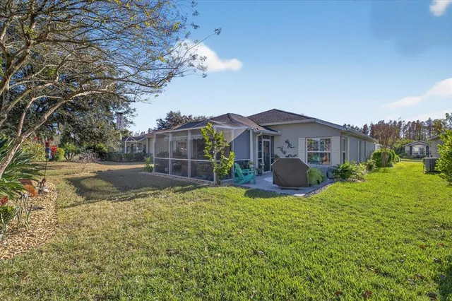 a view of house with yard and green space