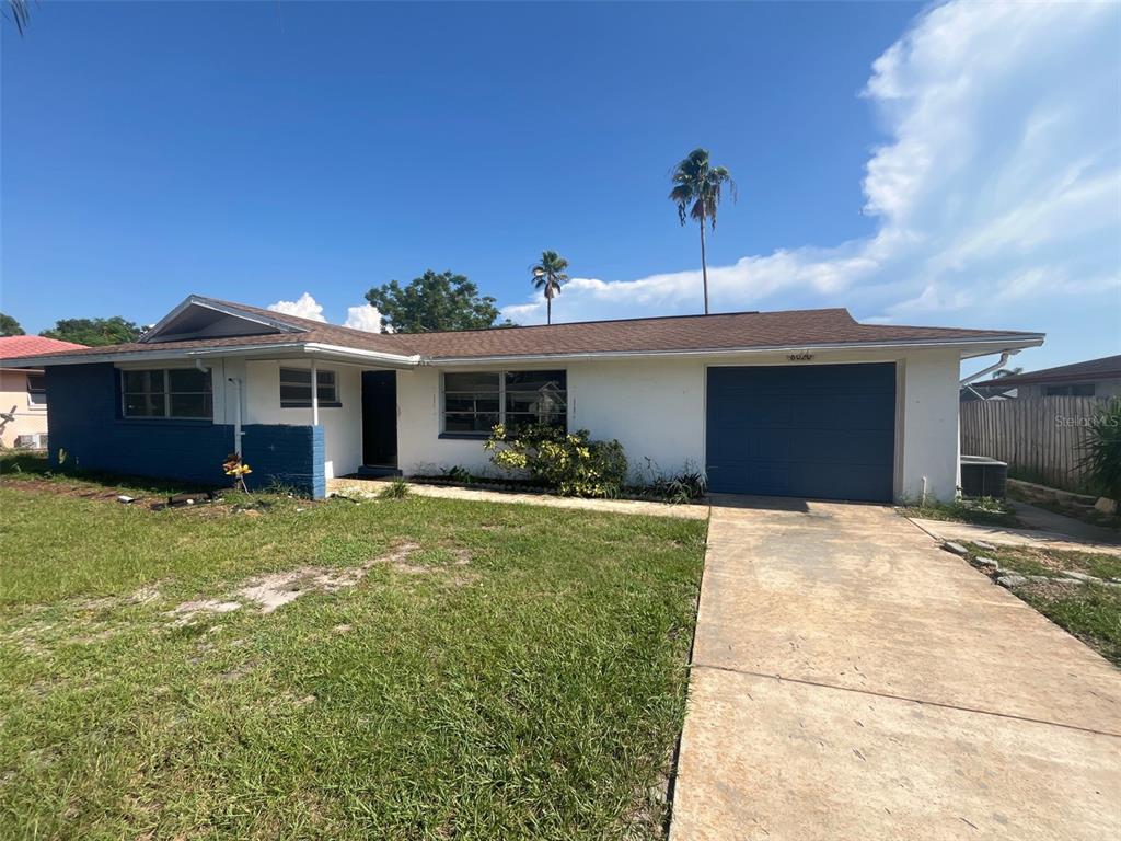 8020 Jasmine Boulevard Port Richey, FL 34668 - Photo 1 of 1 a front view of a house with a garden