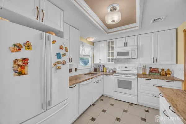 a kitchen with a sink a stove and cabinets