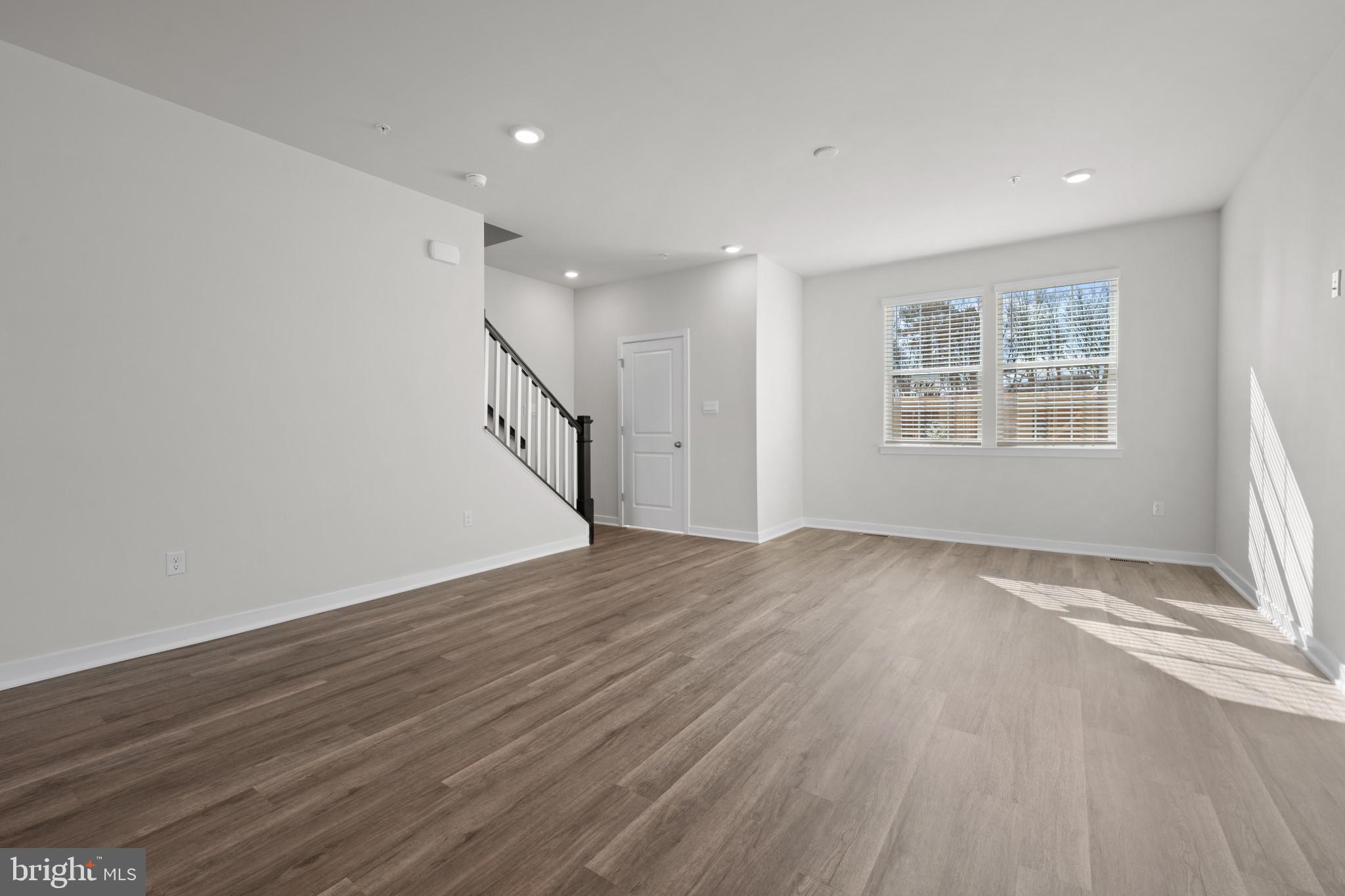 7510 Fern Gully Way Brandywine, MD 20613 - Photo 11 of 31 an empty room with wooden floor and windows