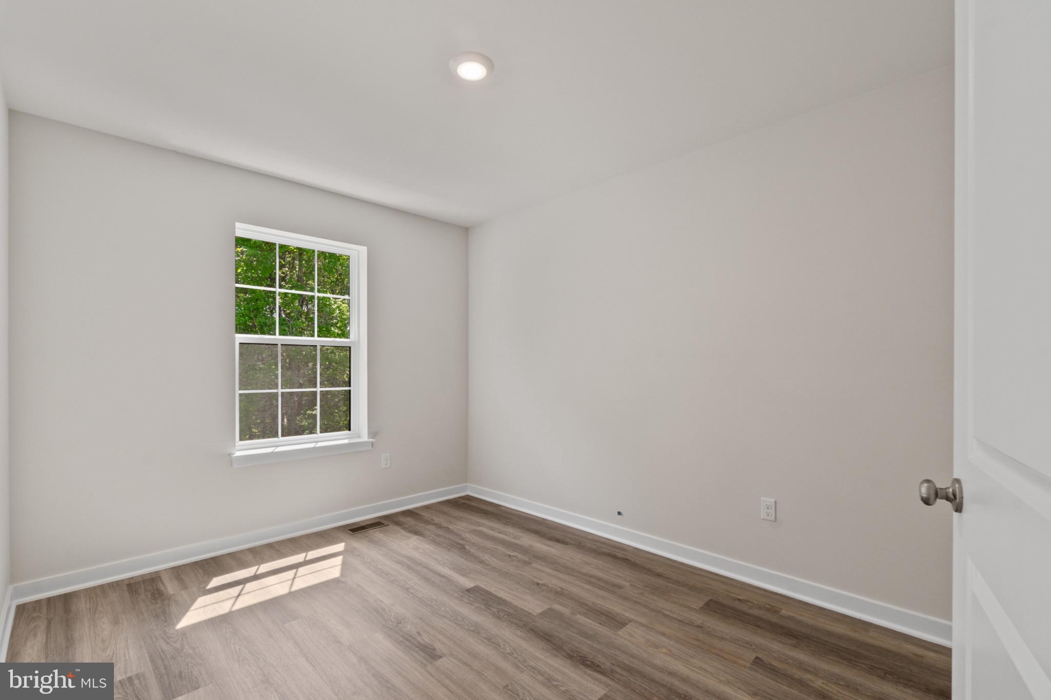 7510 Fern Gully Way Brandywine, MD 20613 - Photo 22 of 31 an empty room with wooden floor and windows