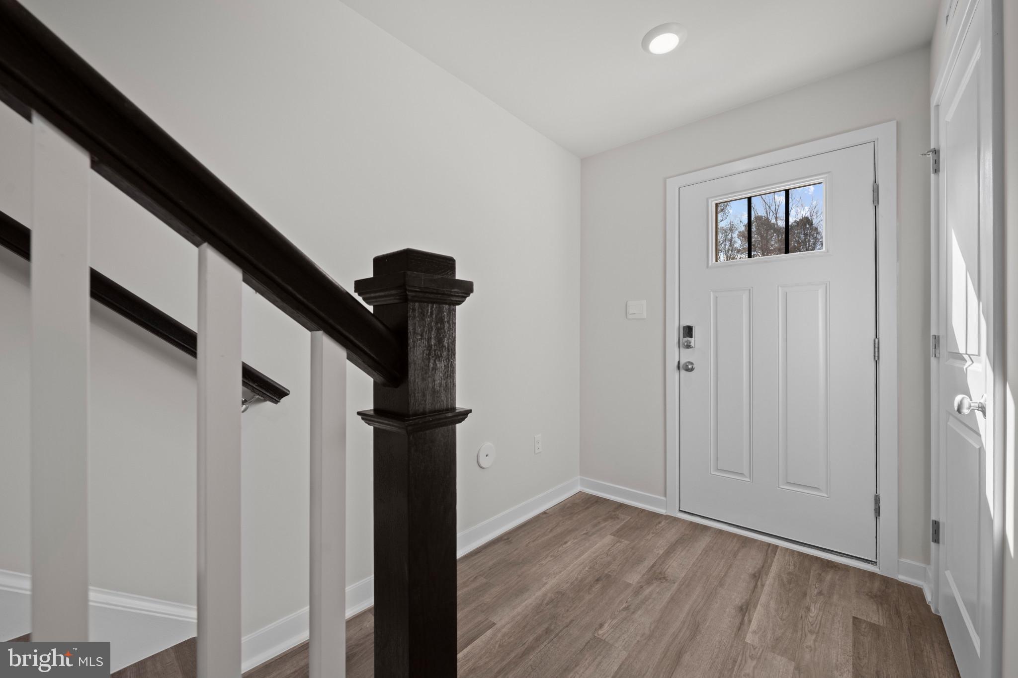 7510 Fern Gully Way Brandywine, MD 20613 - Photo 7 of 31 a view of a hallway with wooden floor and entryway