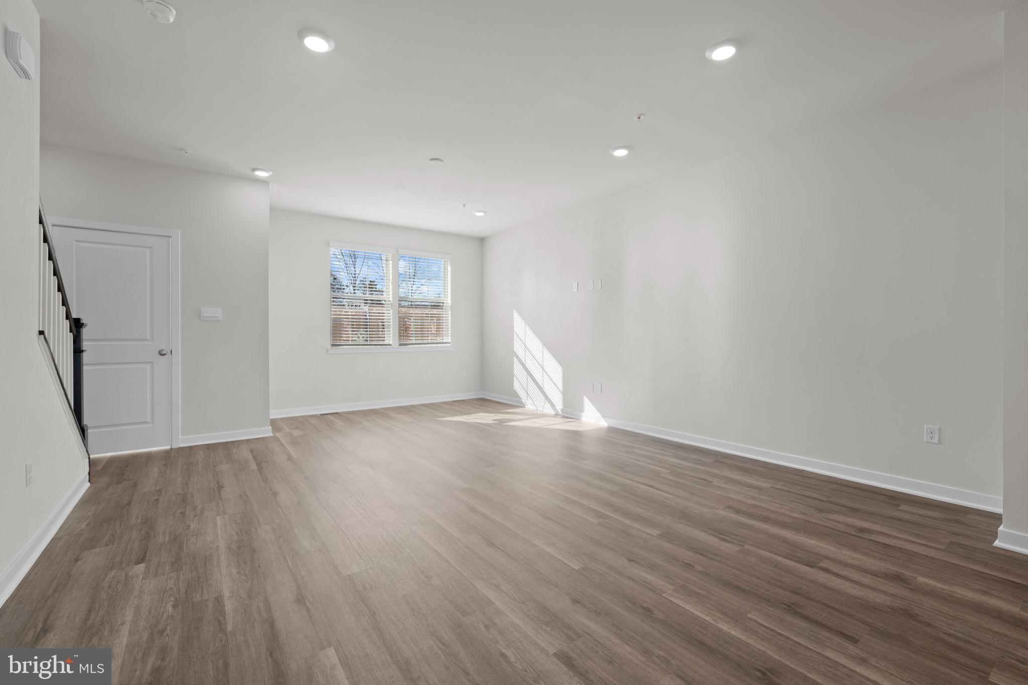 7510 Fern Gully Way Brandywine, MD 20613 - Photo 10 of 31 a view of an empty room with wooden floor and a window