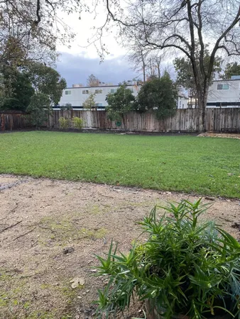 a view of a yard with a house in the background