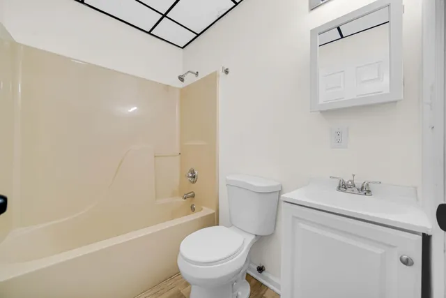 a kitchen with a sink dishwasher a stove and a refrigerator with wooden floor