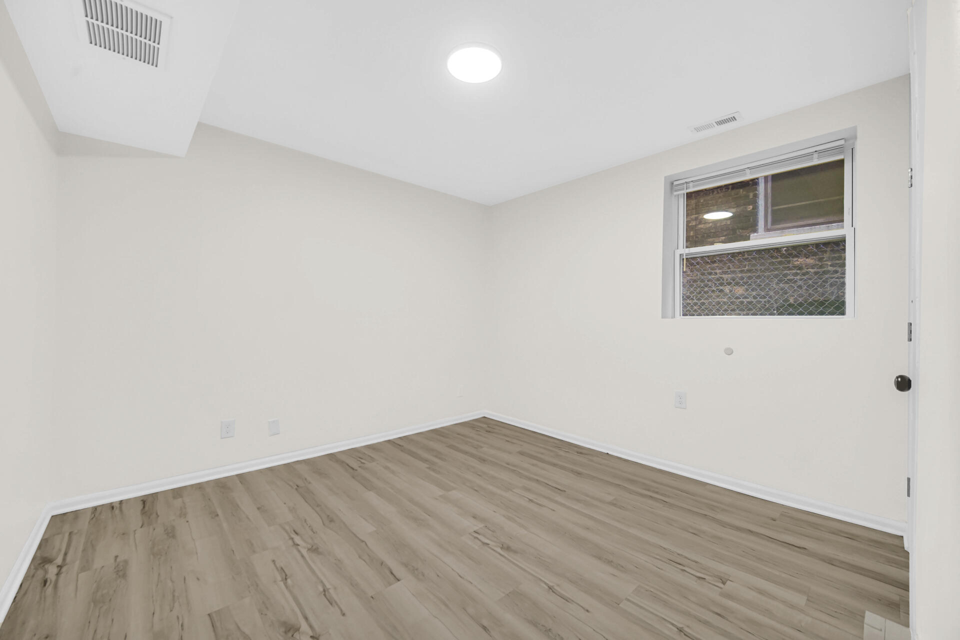 3501 Fir Street East Chicago, IN 46312 - Photo 20 of 26 an empty room with wooden floor and windows