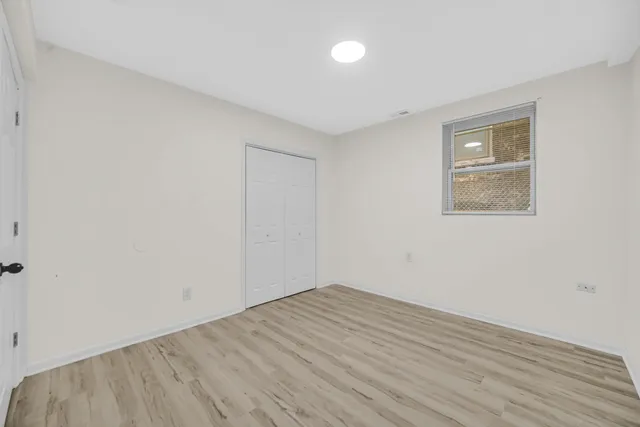 a city street lined with parked cars and buildings