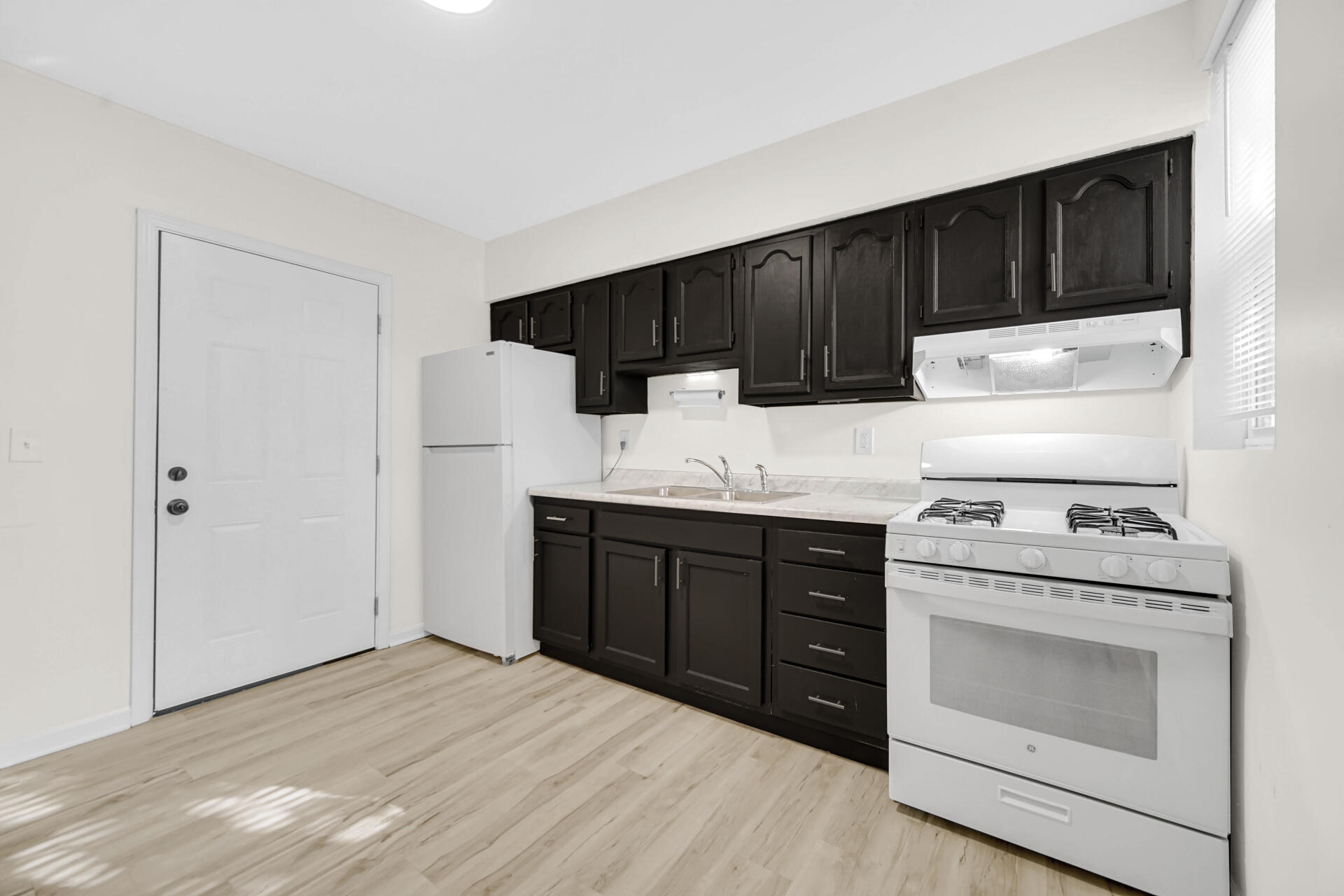3501 Fir Street East Chicago, IN 46312 - Photo 6 of 26 a kitchen with a stove top oven sink and cabinets