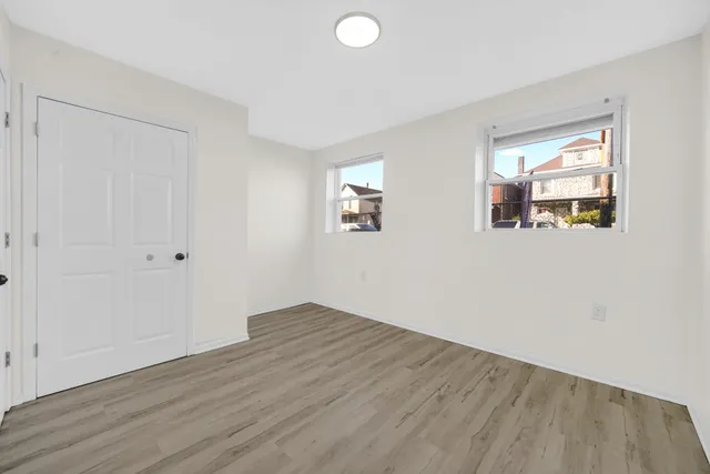 a view of empty room with a sink and wooden floor