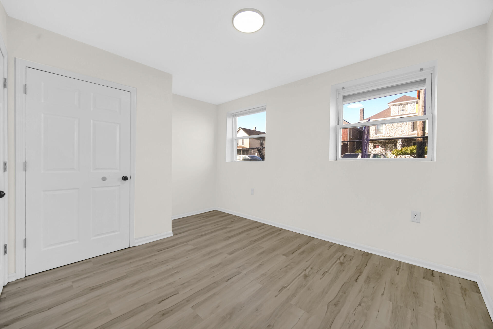 3501 Fir Street East Chicago, IN 46312 - Photo 8 of 26 an empty room with wooden floor and windows