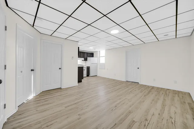 a kitchen with a sink dishwasher a white stove refrigerator and cabinets