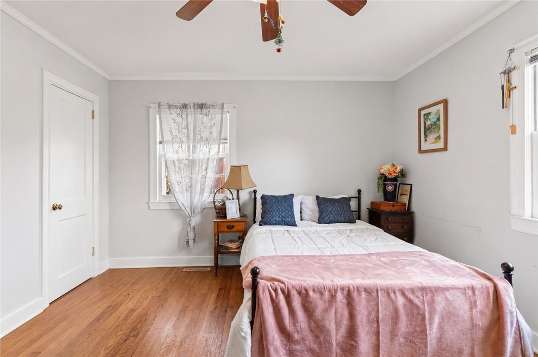 26 Oak Dr Extension Honea Path, SC 29654 - Photo 10 of 31 Rich hardwood flooring complements the simple lines of this quiet bedroom space.