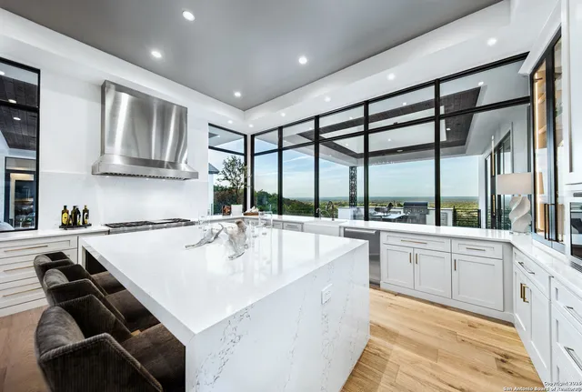 a large white kitchen with a large window