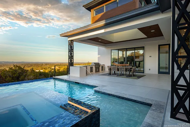 a view of a patio with lawn chairs floor to ceiling window and an outdoor space