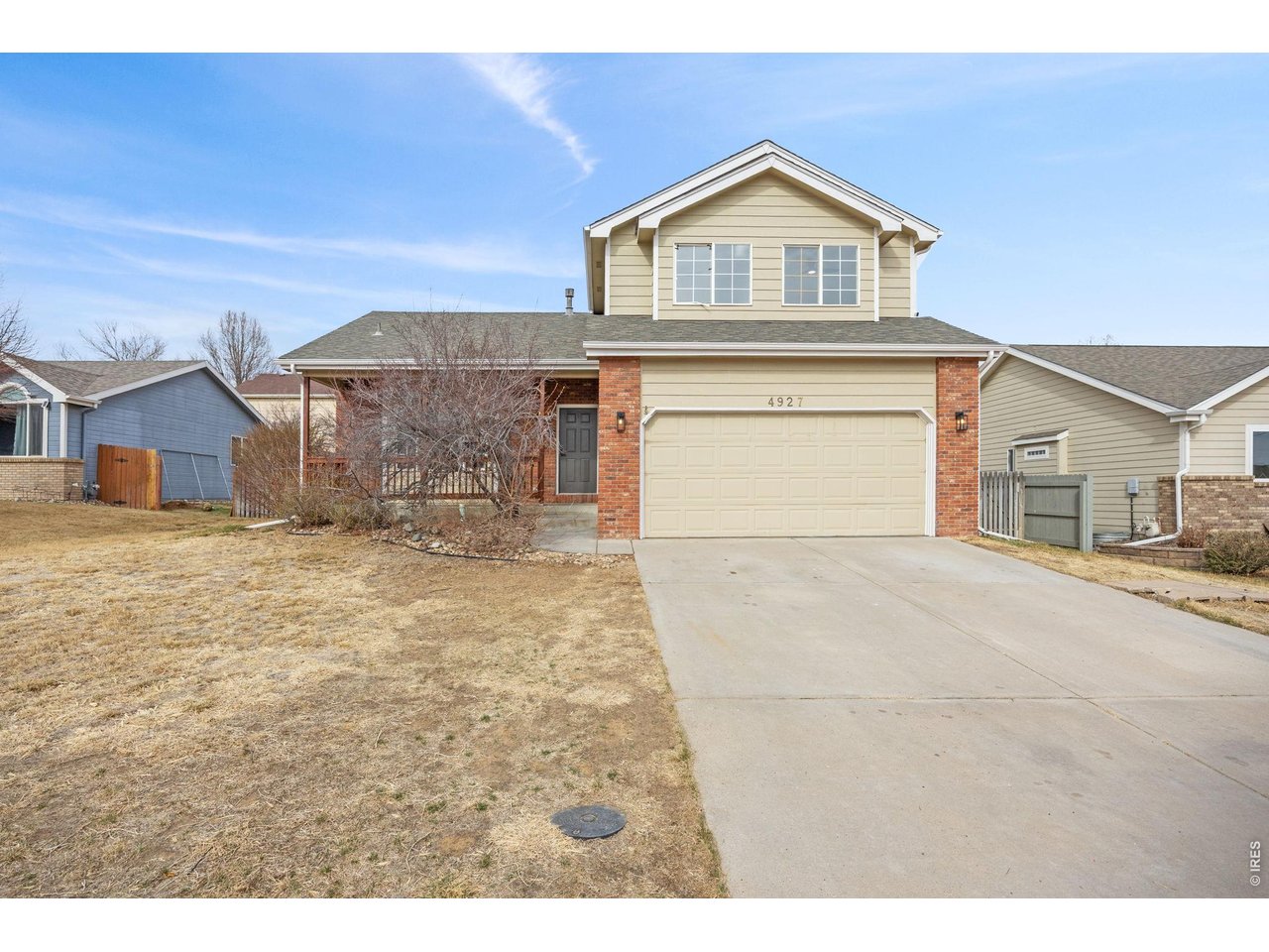4927 30th Street Greeley, CO 80634 - Photo 1 of 35 a front view of a house with a yard and garage