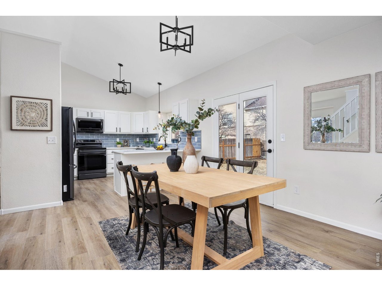 4927 30th Street Greeley, CO 80634 - Photo 11 of 35 a view of a dining room with furniture and wooden floor
