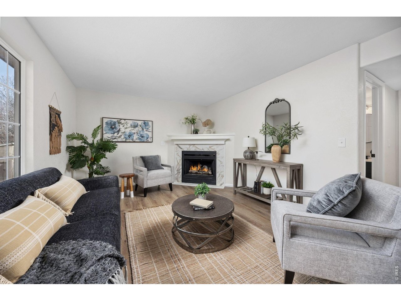4927 30th Street Greeley, CO 80634 - Photo 12 of 35 a living room with furniture and a fireplace