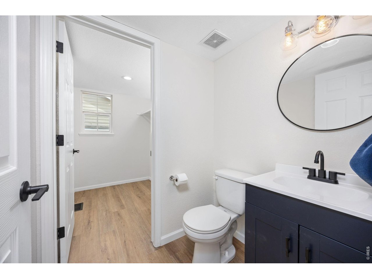 4927 30th Street Greeley, CO 80634 - Photo 15 of 35 a bathroom with a toilet a sink and a mirror