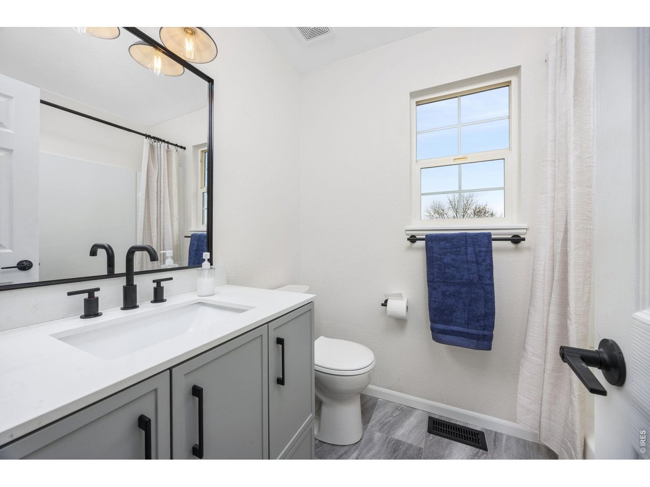4927 30th Street Greeley, CO 80634 - Photo 23 of 35 a bathroom with a sink a toilet and mirror